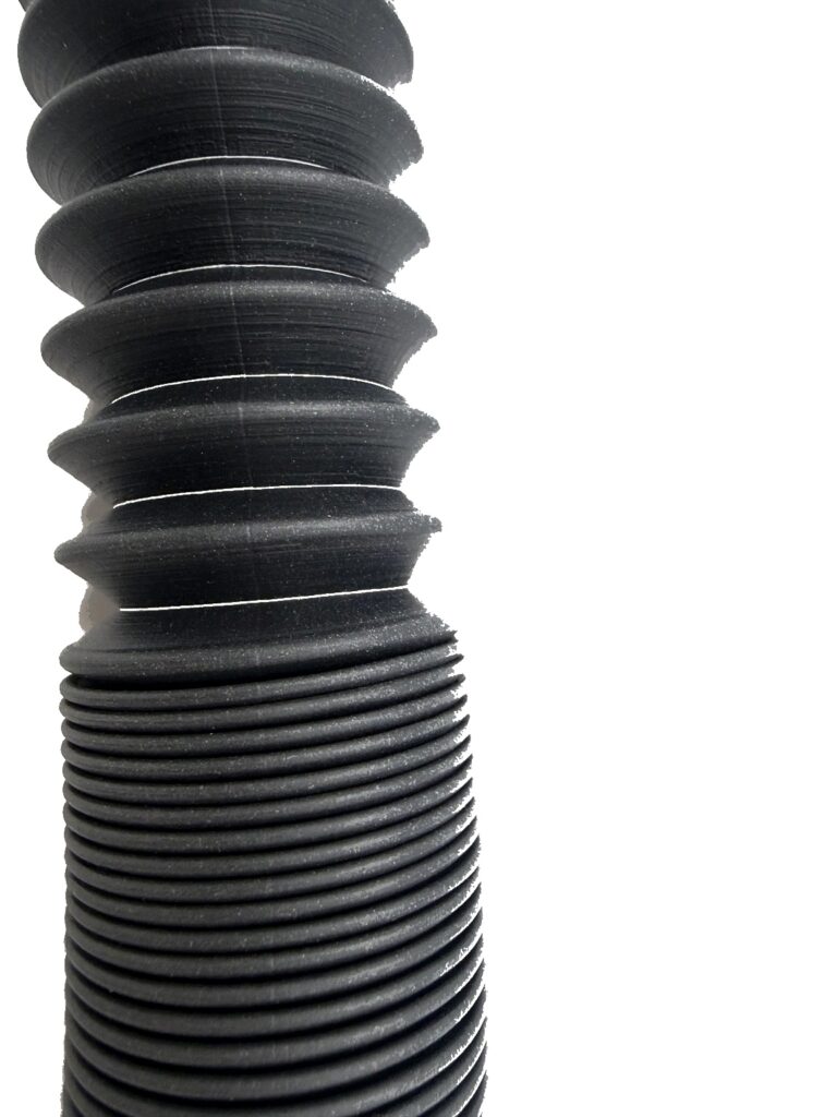 Black warm air appliance hose with ribbed body